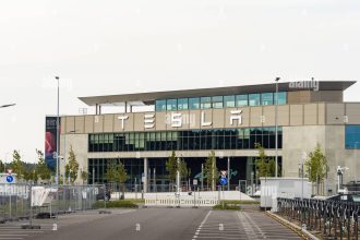 tesla gigafactory berlin brandenburg entrance with the logo sign building exterior of the huge factory of the bev manufacturer 2XW52G4