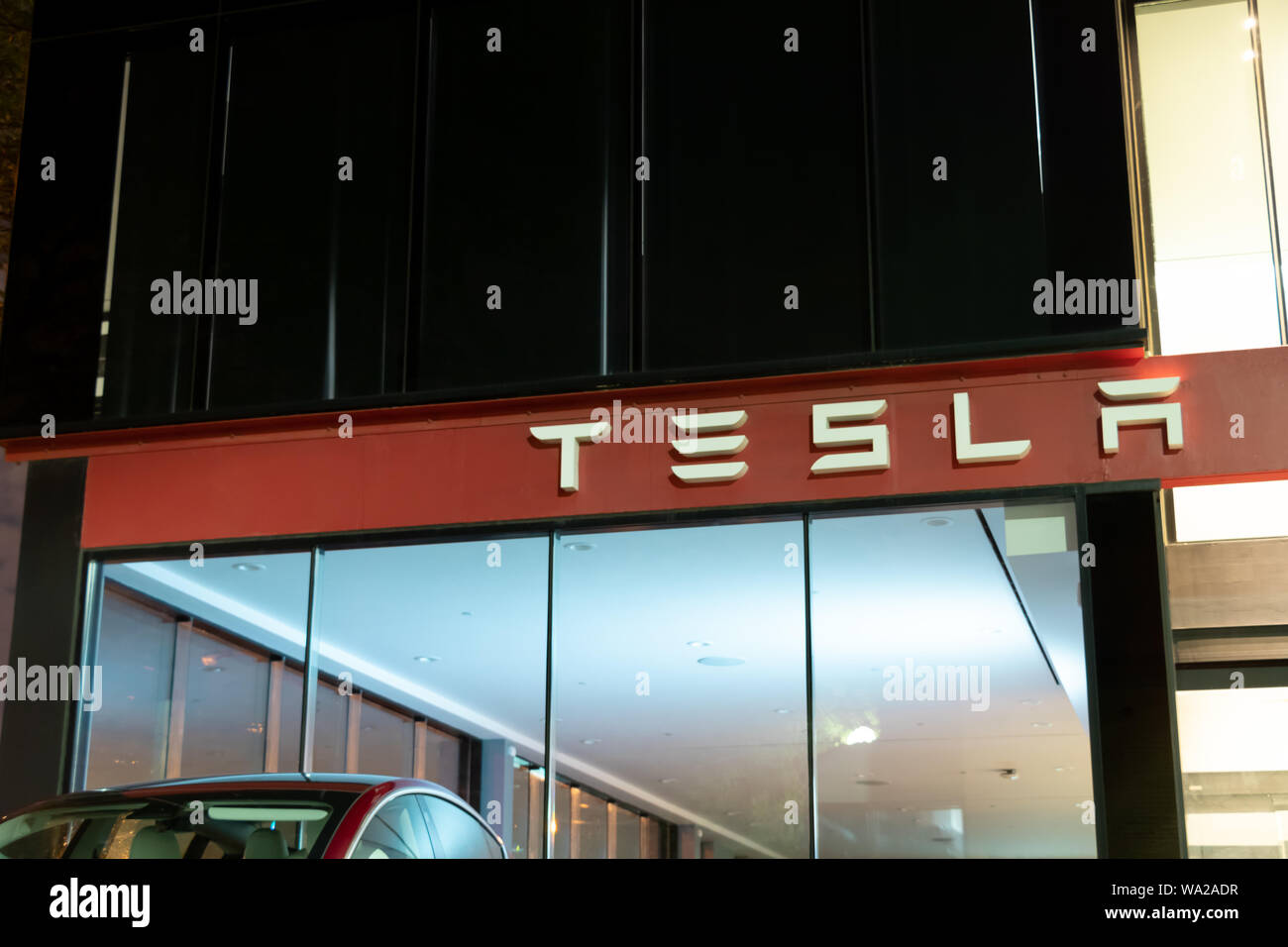 Tesla text logo on-top of Tesla Showroom and Service Center at ...