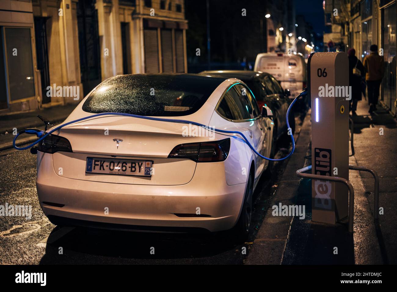 White Tesla car charging at a station in Paris, France Stock Photo ...